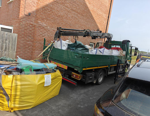 Skip Bag Hire Exeter. Full Skip bag showing waste and capacity.